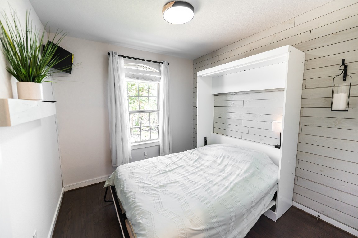608 Pecan Bottom Trail Georgetown, TX 78628 - Photo 20 of 30 Bedroom with dark wood-style flooring and wooden walls