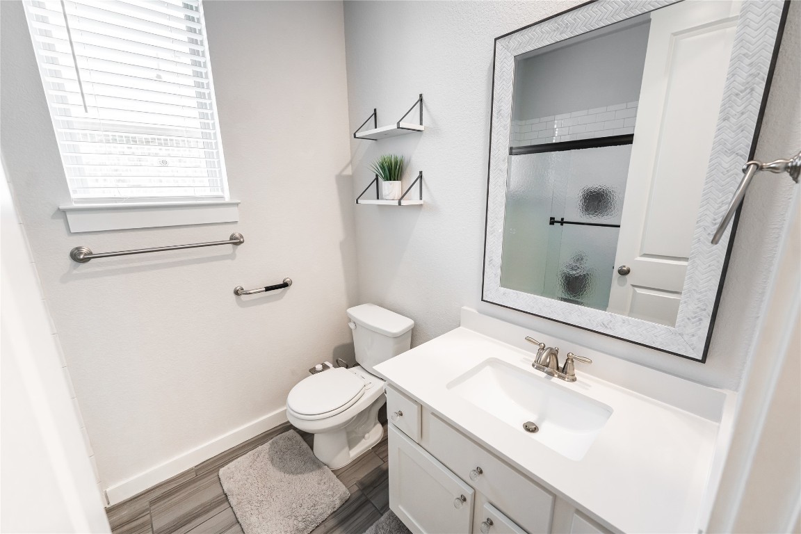 608 Pecan Bottom Trail Georgetown, TX 78628 - Photo 21 of 30 Bathroom featuring a stall shower, vanity, and dark wood-style floors