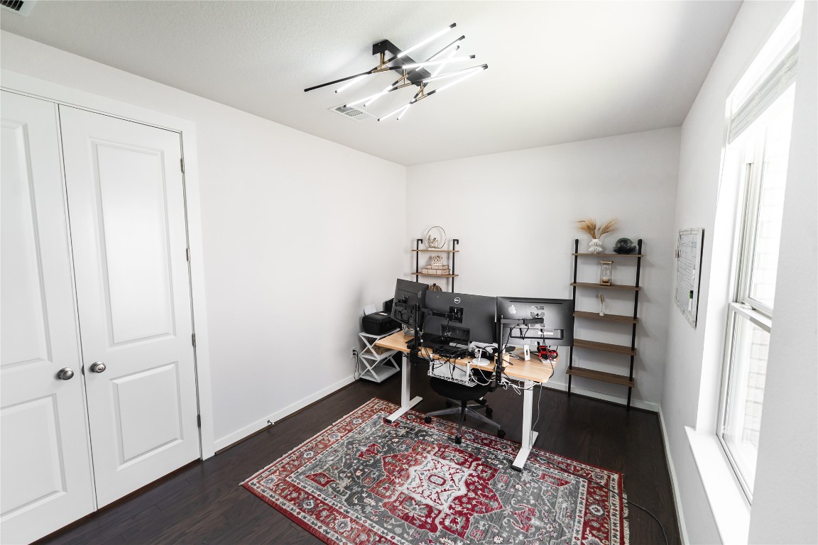 608 Pecan Bottom Trail Georgetown, TX 78628 - Photo 22 of 30 Home office with dark wood finished floors and baseboards