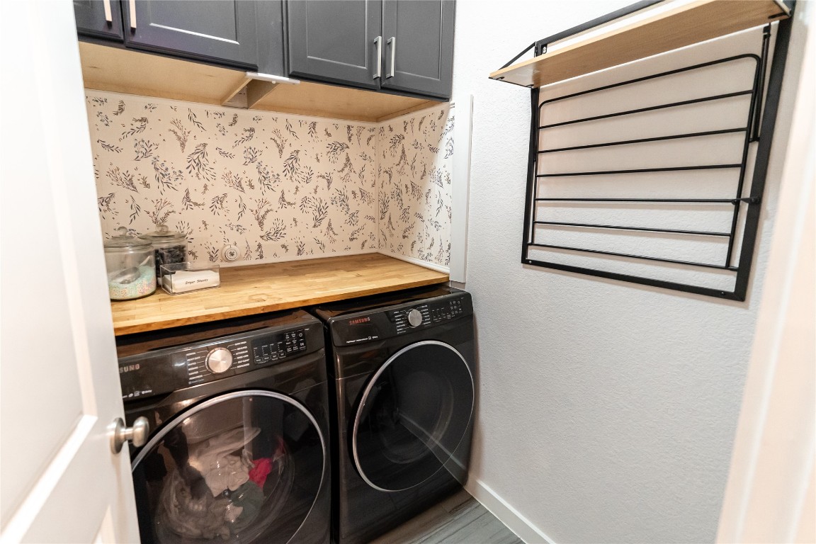 608 Pecan Bottom Trail Georgetown, TX 78628 - Photo 24 of 30 Washroom featuring cabinet space, independent washer and dryer, and a textured wall