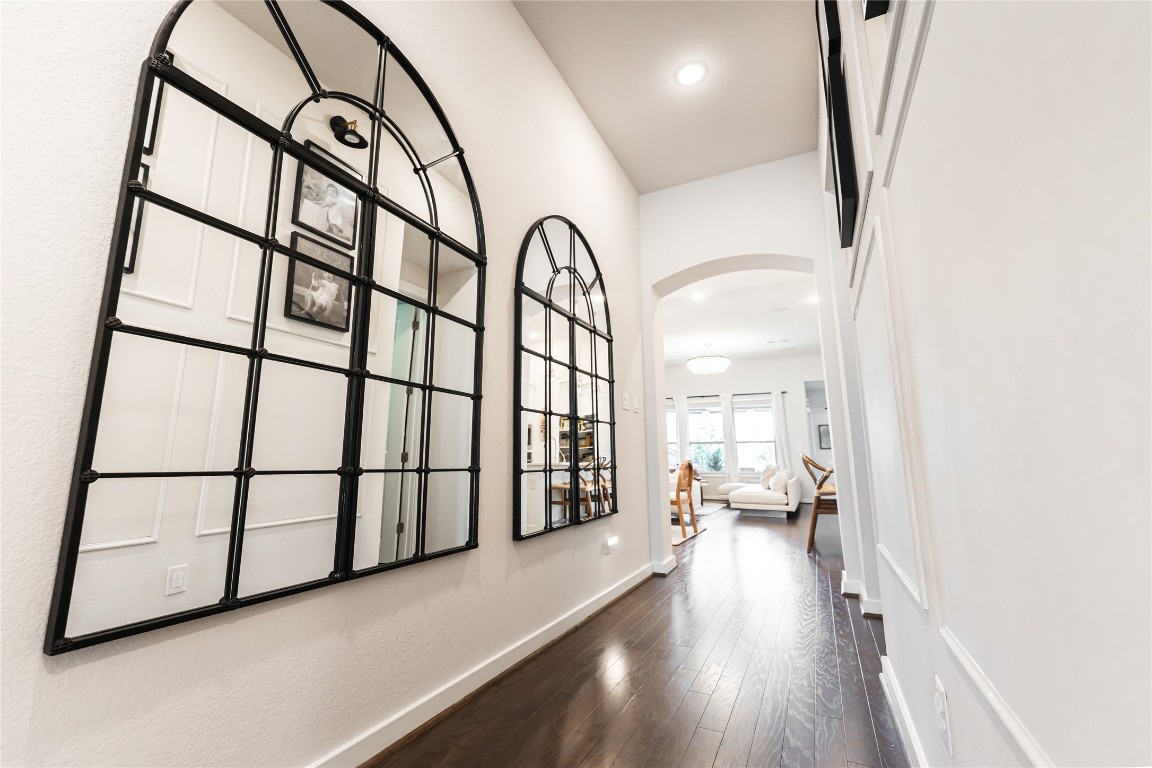 608 Pecan Bottom Trail Georgetown, TX 78628 - Photo 4 of 30 Corridor with arched walkways, dark wood-style flooring, and recessed lighting
