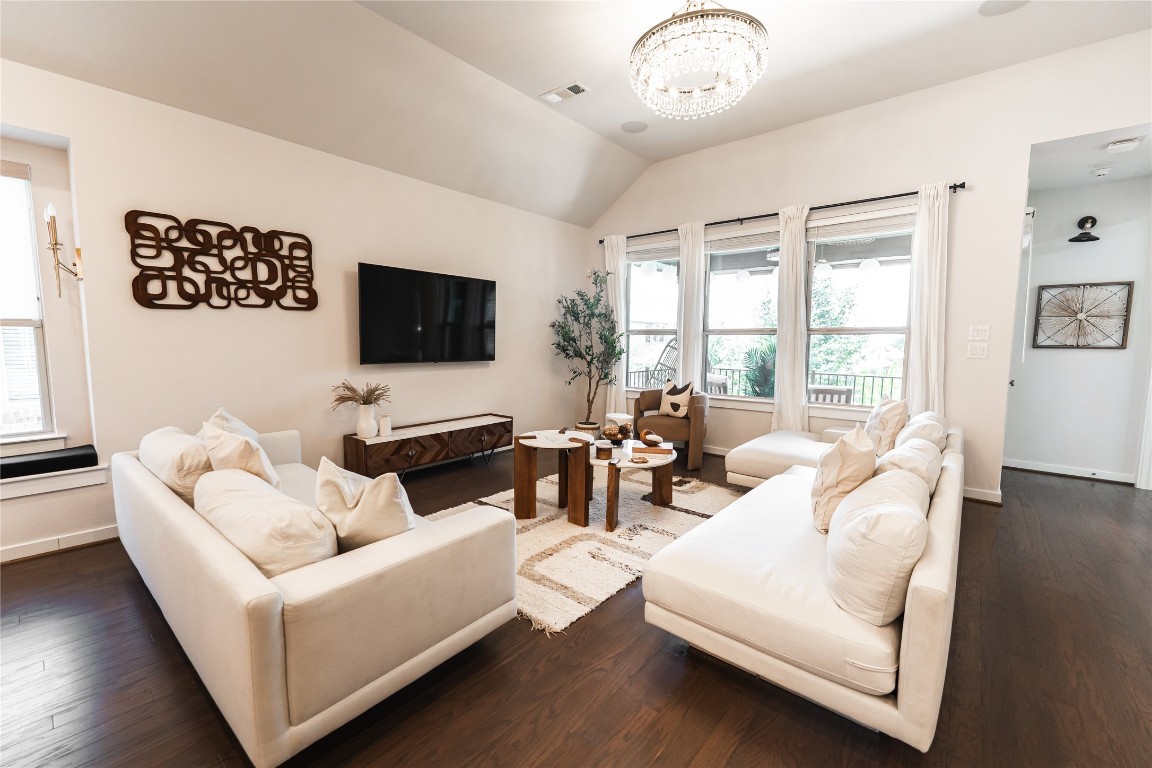 608 Pecan Bottom Trail Georgetown, TX 78628 - Photo 9 of 30 Living area with dark wood finished floors, lofted ceiling, and a chandelier