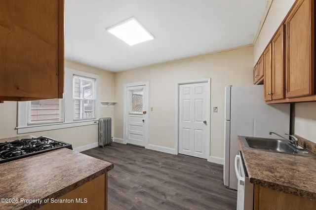 a kitchen with a stove and a refrigerator