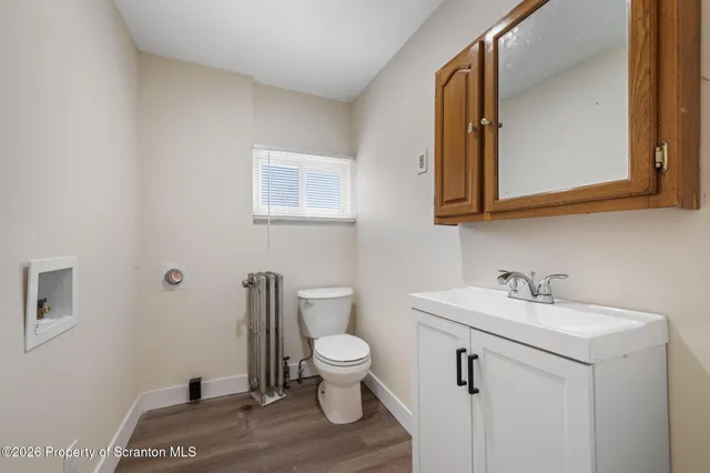 a bathroom with a sink a toilet and mirror