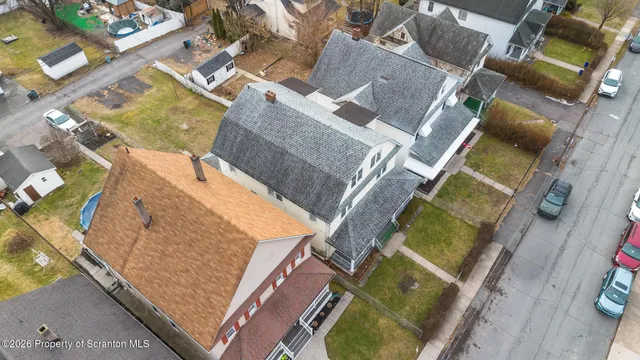 an aerial view of a house with a swimming pool