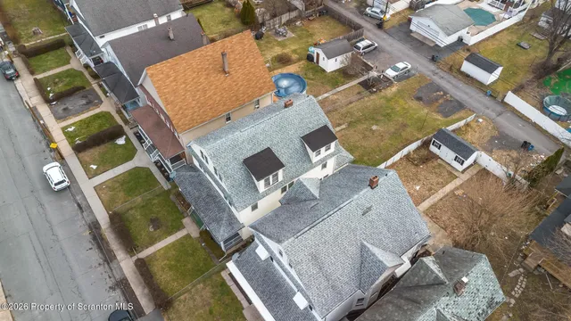 an aerial view of a house with a swimming pool and outdoor space