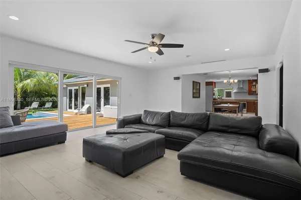 a kitchen with stainless steel appliances kitchen island granite countertop a refrigerator a stove top oven and a sink