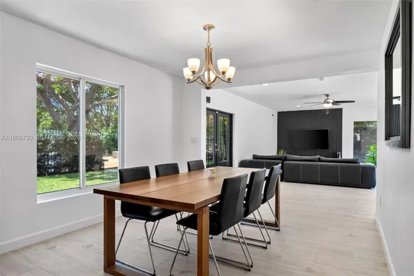 a kitchen with stainless steel appliances granite countertop a refrigerator a sink and a stove