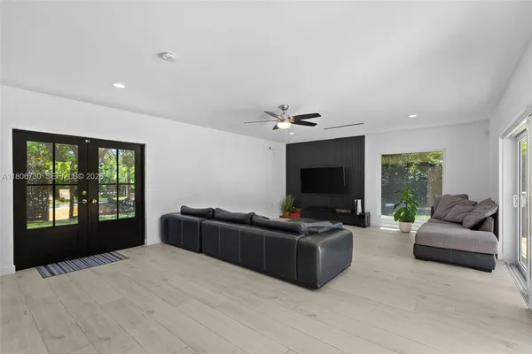 a view of a dining room with furniture a livingroom and chandelier