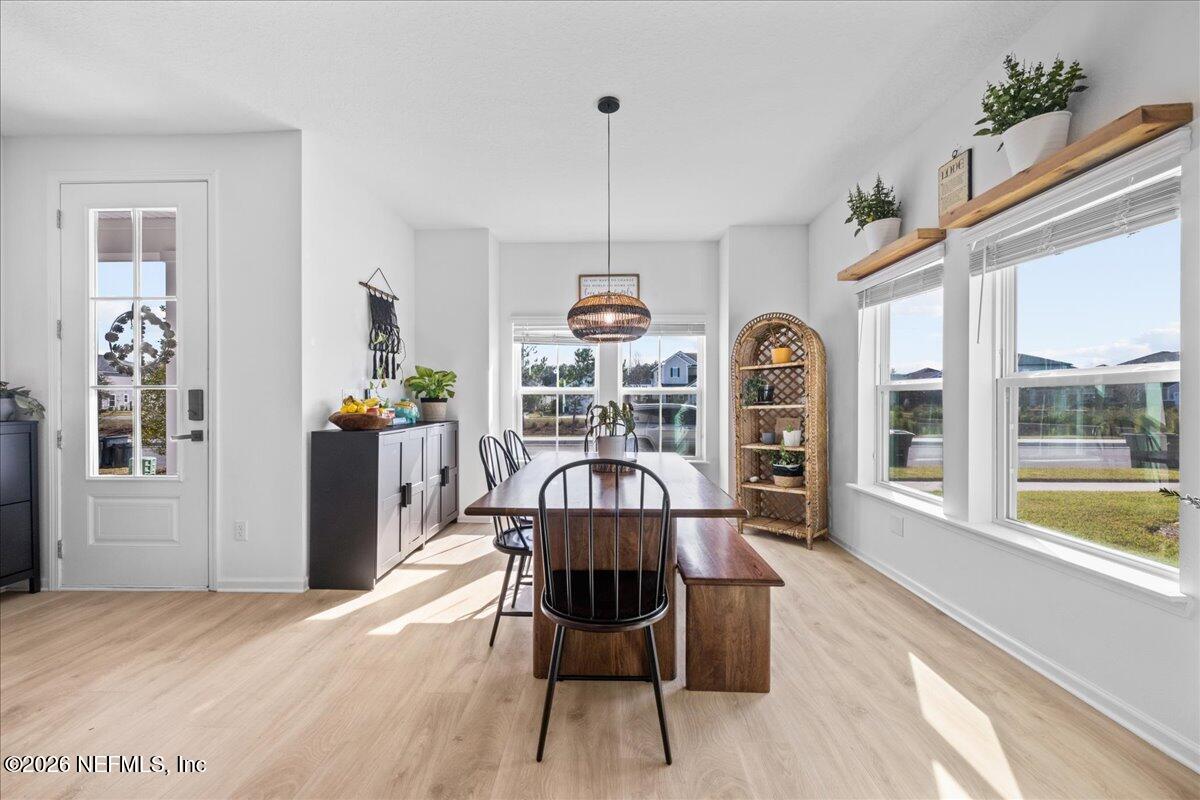 92 Patina Place St. Augustine, FL 32092 - Photo 3 of 26 a view of a dining room with furniture window and wooden floor