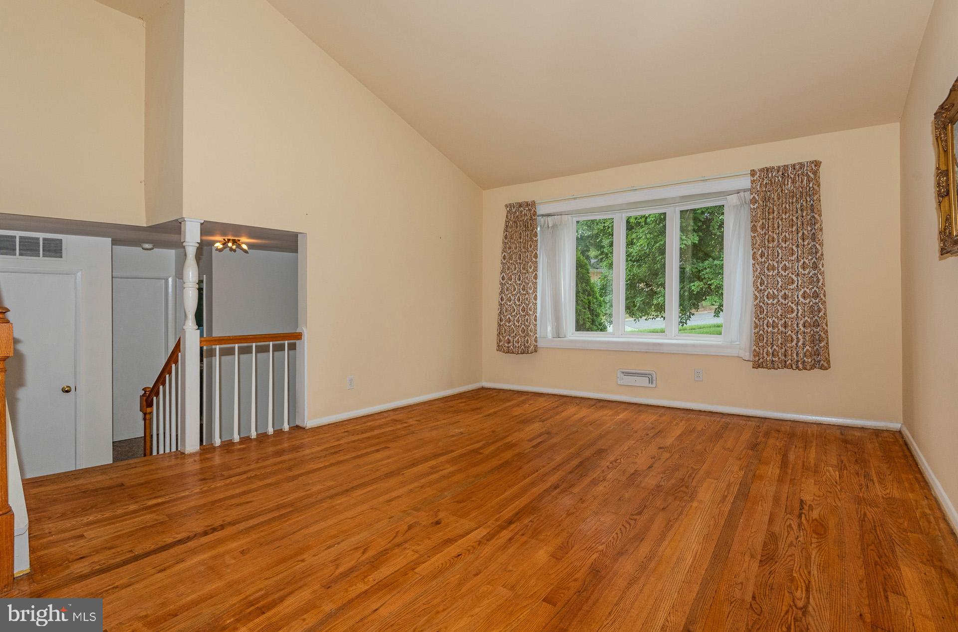 208 Ardmore Road Linthicum Heights, MD 21090 - Photo 11 of 58 a view of an empty room with wooden floor and a window
