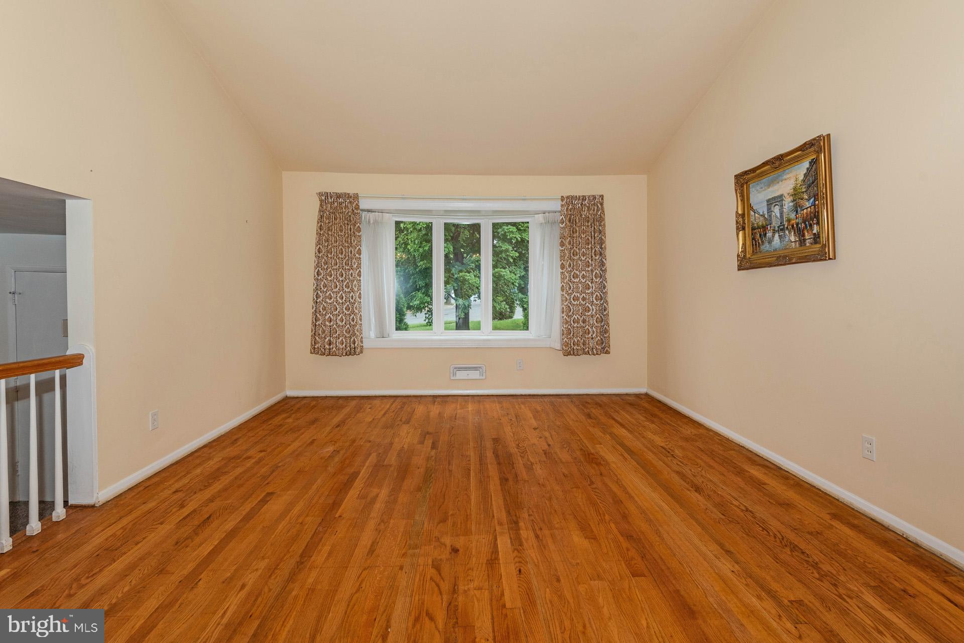 208 Ardmore Road Linthicum Heights, MD 21090 - Photo 12 of 58 a view of an empty room with wooden floor and a window