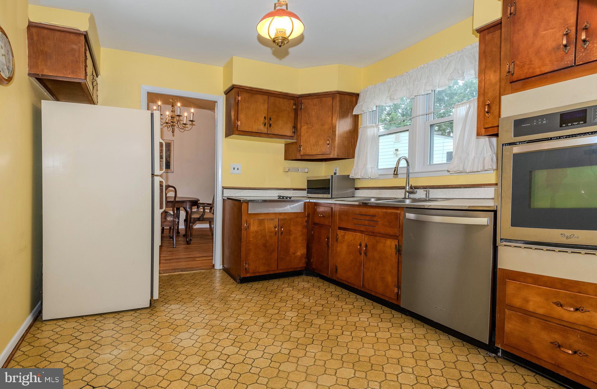 208 Ardmore Road Linthicum Heights, MD 21090 - Photo 15 of 58 a kitchen with stainless steel appliances a sink and a refrigerator