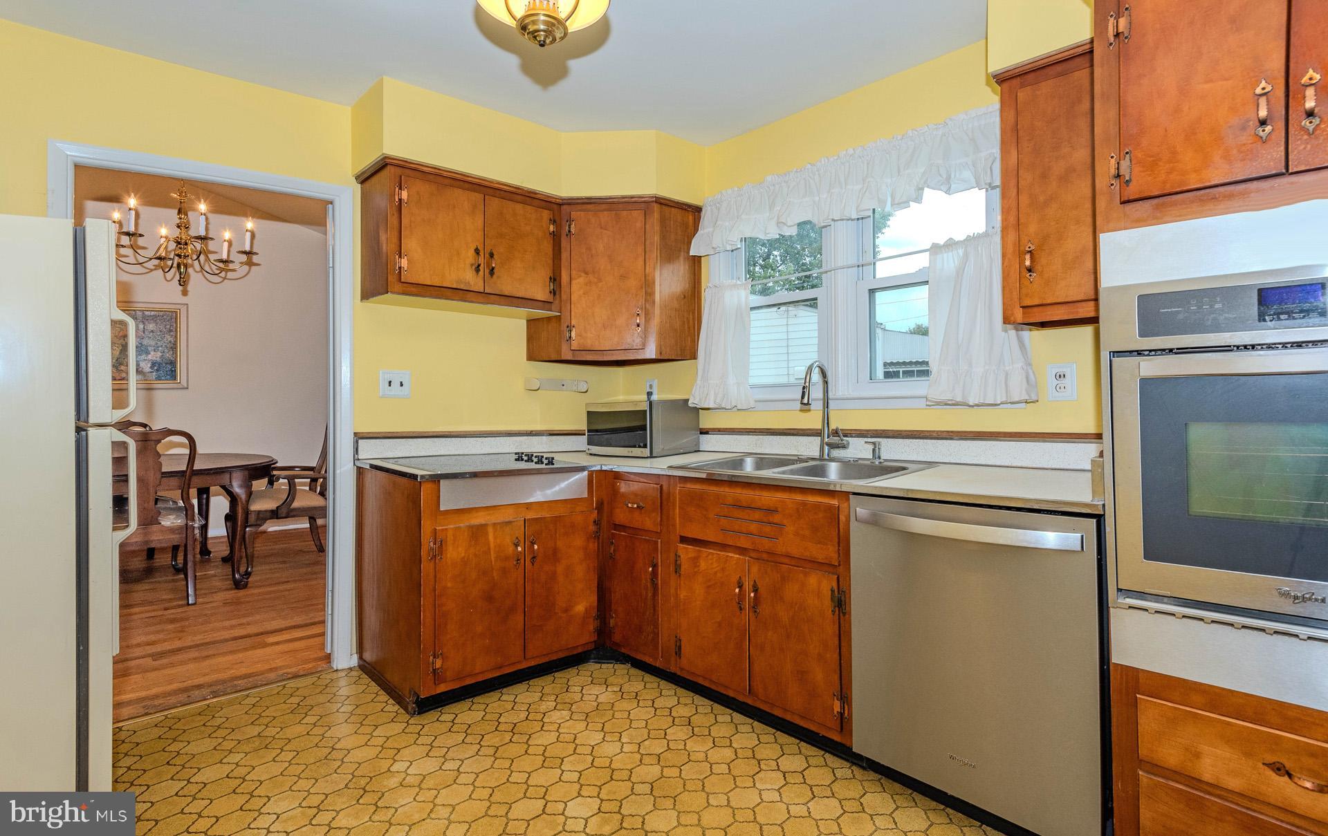 208 Ardmore Road Linthicum Heights, MD 21090 - Photo 17 of 58 a kitchen with stainless steel appliances granite countertop a sink and cabinets