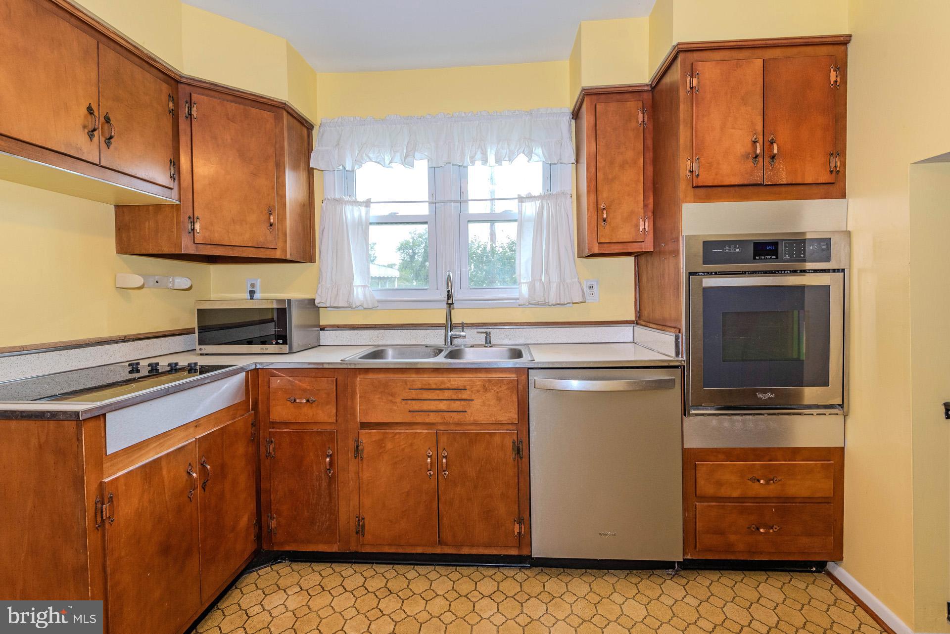 208 Ardmore Road Linthicum Heights, MD 21090 - Photo 18 of 58 a kitchen with stainless steel appliances granite countertop a stove a sink and a refrigerator
