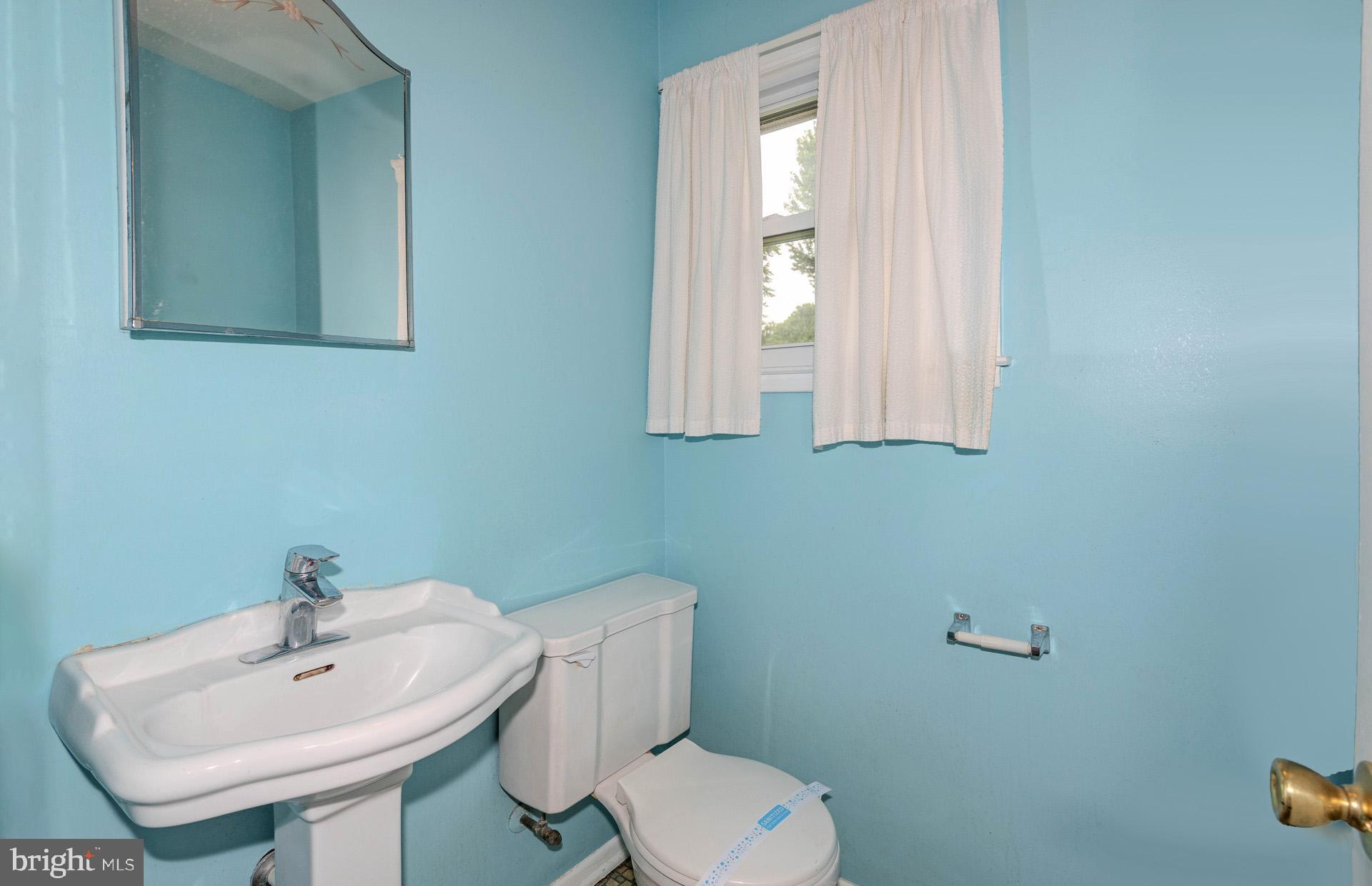 208 Ardmore Road Linthicum Heights, MD 21090 - Photo 22 of 58 a bathroom with a toilet a sink and mirror