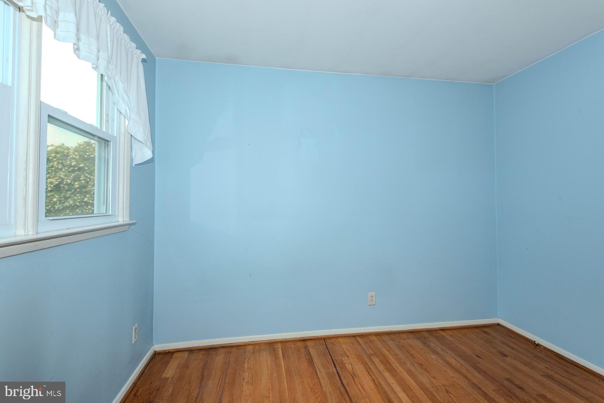 208 Ardmore Road Linthicum Heights, MD 21090 - Photo 26 of 58 a view of an empty room with wooden floor and a window