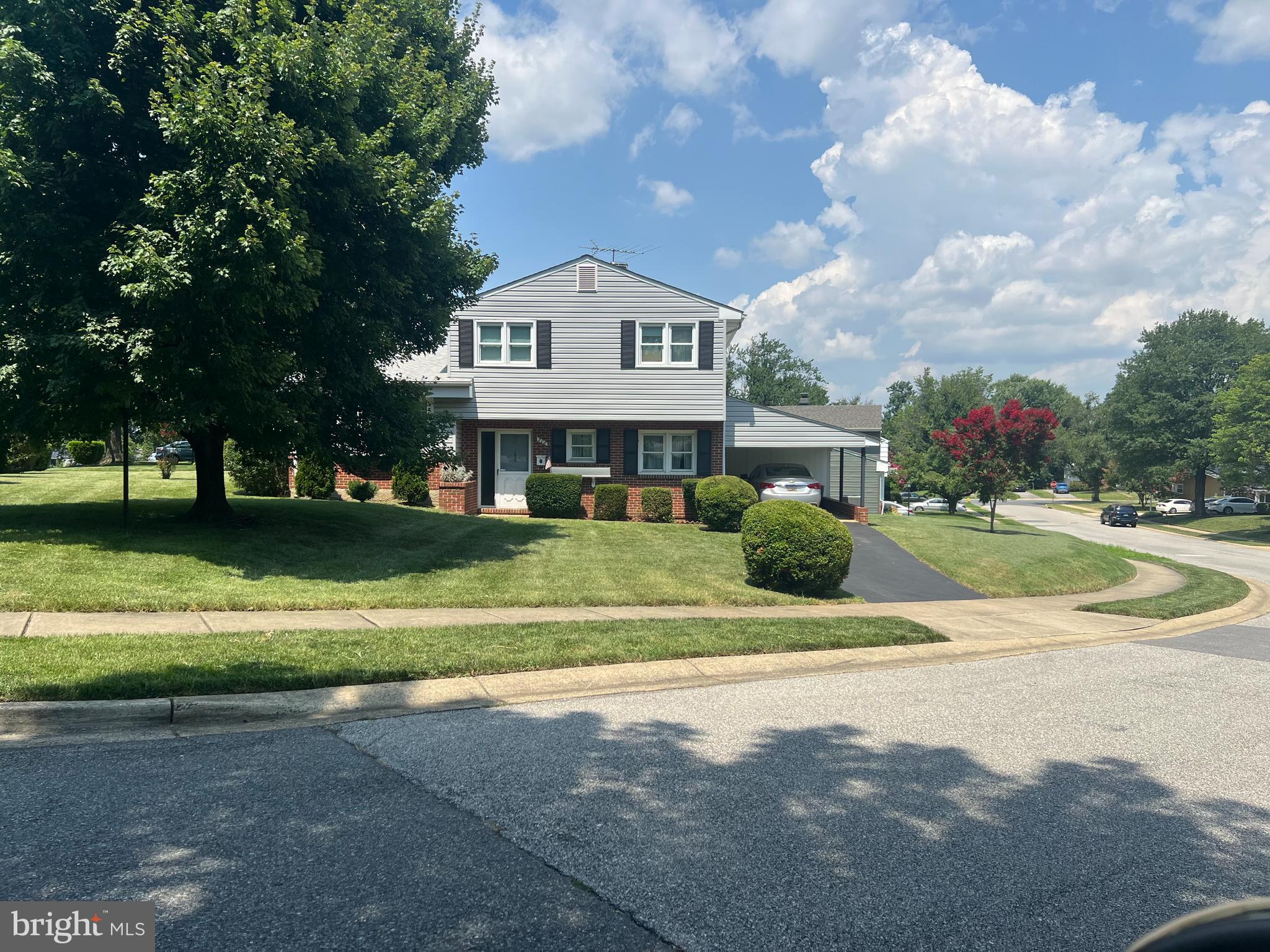 208 Ardmore Road Linthicum Heights, MD 21090 - Photo 52 of 58 a view of big white house with a big yard and potted plants and large trees