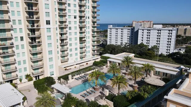 a view of a patio with lawn chairs