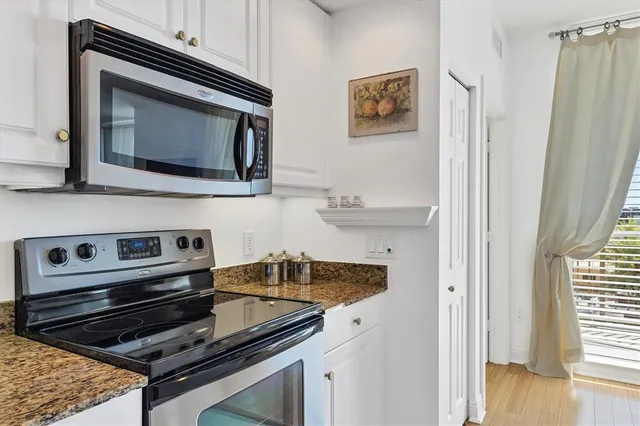 a view of a workspace with furniture and wooden floor