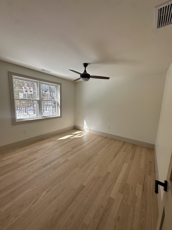 104 Page Road Bedford, MA 01730 - Photo 17 of 24 wooden floor in an empty room with a window