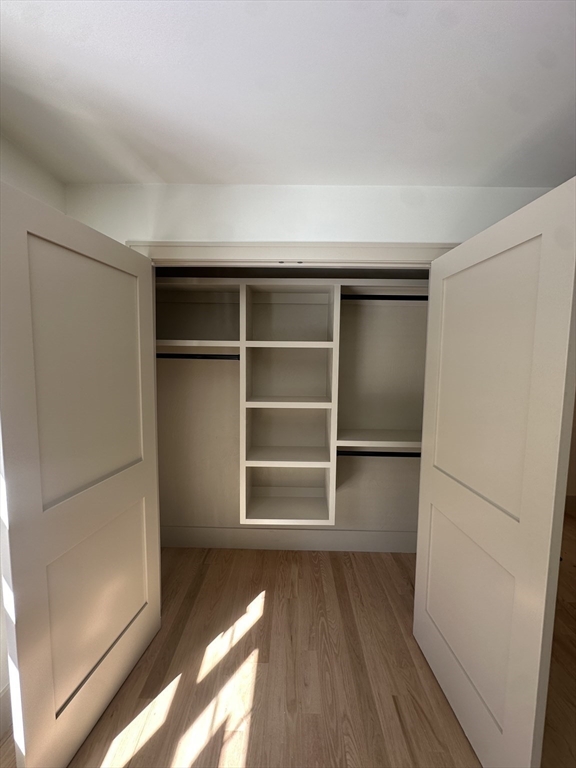 104 Page Road Bedford, MA 01730 - Photo 19 of 24 a view of an empty walk in closet