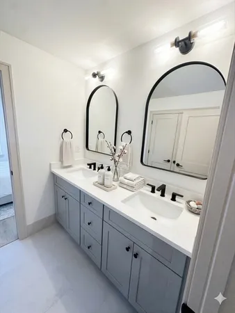 a bathroom with 2 sink and a mirror