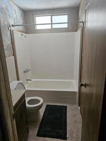 a bath tub sitting in a bathroom next to a window