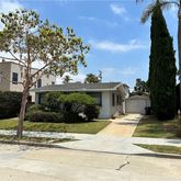 a view of a house with a garden and pathway