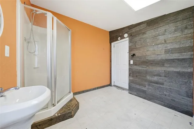 a bathroom with a tub shower and sink