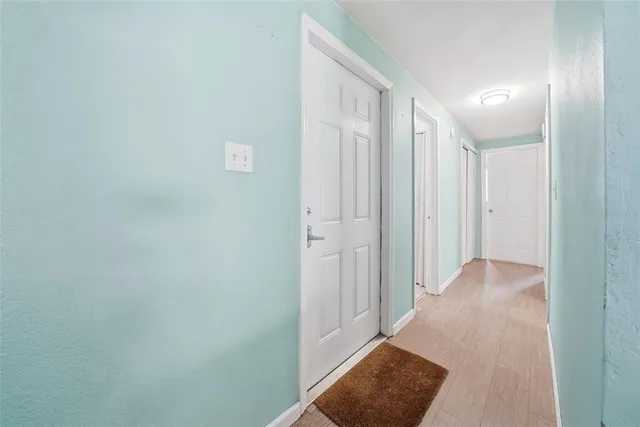 a view of hallway with a rug and a window
