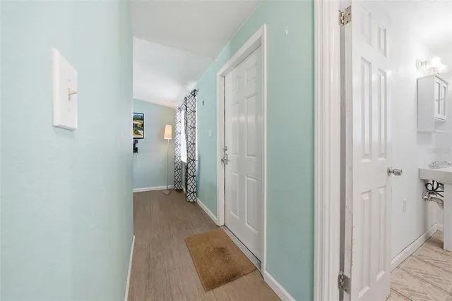 a view of a hallway with wooden floor