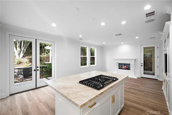 a view of a kitchen with furniture and wooden floor