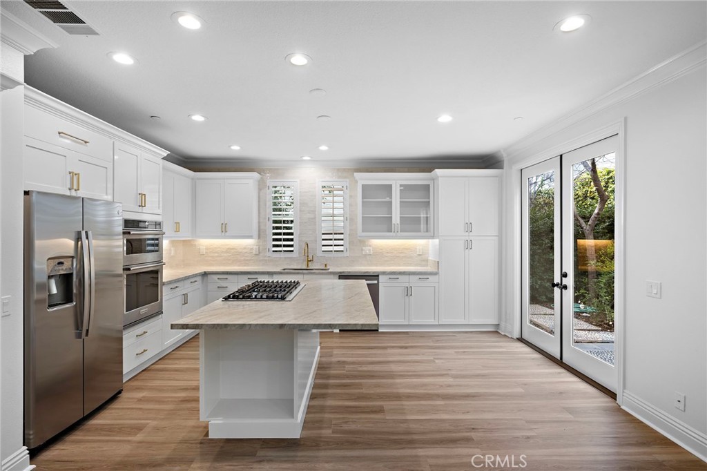 5 Citrus Lane Ladera Ranch, CA 92694 - Photo 14 of 54 a kitchen with stainless steel appliances kitchen island granite countertop a stove and a refrigerator