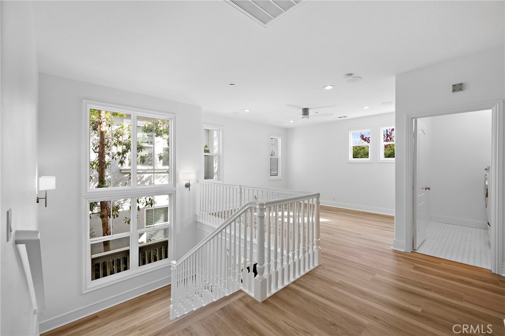 5 Citrus Lane Ladera Ranch, CA 92694 - Photo 21 of 54 a view of a hallway with wooden floor and windows