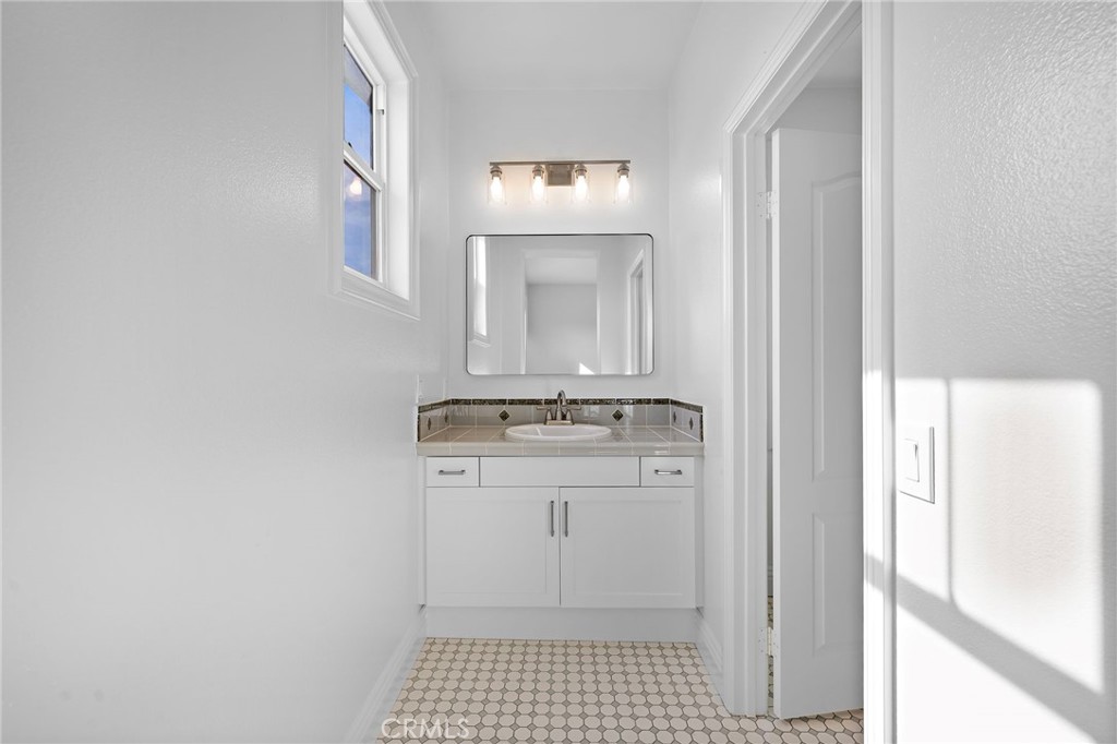 5 Citrus Lane Ladera Ranch, CA 92694 - Photo 28 of 54 a bathroom with a sink and a mirror