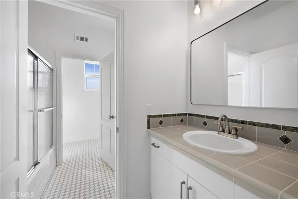 a bathroom with a tub sink and window