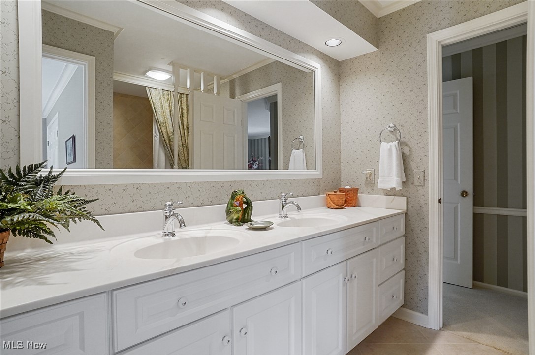 4432 Ira Road Akron, OH 44333 - Photo 34 of 50 Full bathroom with wallpapered walls, double vanity, crown molding, and tile patterned floors