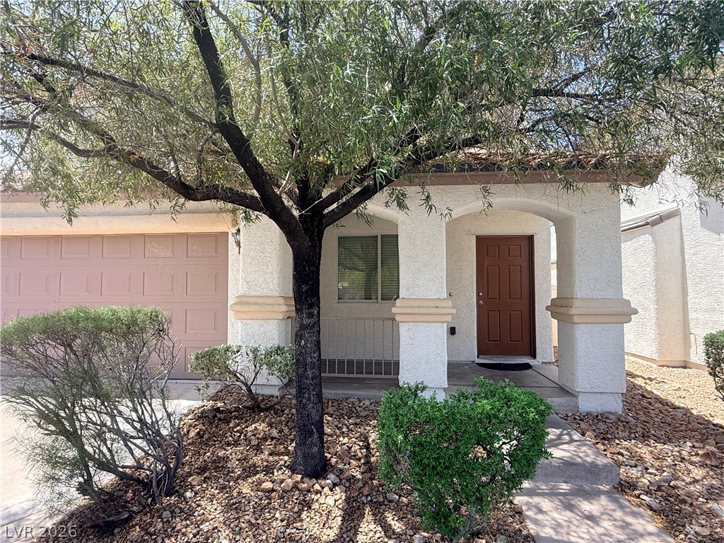 11953 Fairfax Ridge Street Las Vegas, NV 89183 - Photo 2 of 32 A graceful tree shades the inviting front entry of this charming residence.