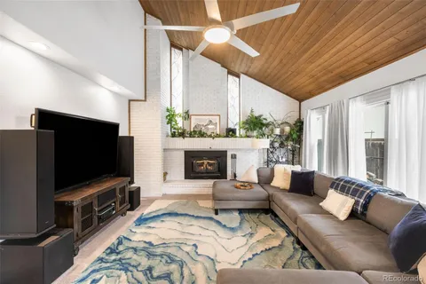 a living room with furniture ceiling fan and a rug