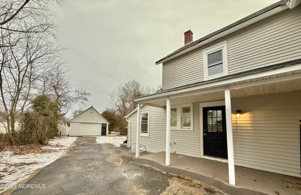 a view of a house with a yard and garage