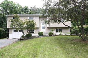 89 Rolling Meadows Road Middletown, NY 10940 - Photo 1 of 1 a front view of a house with a garden and trees