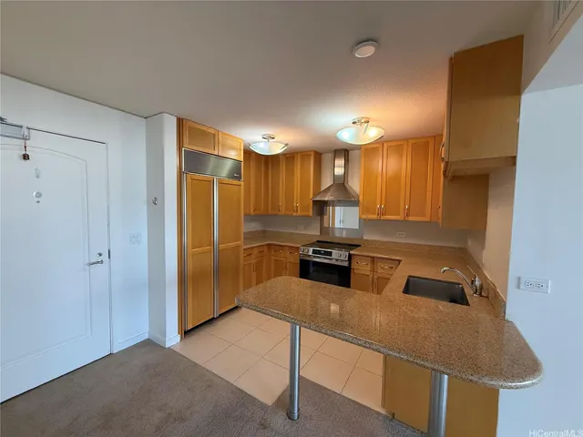 a kitchen with stainless steel appliances granite countertop a sink refrigerator and cabinets