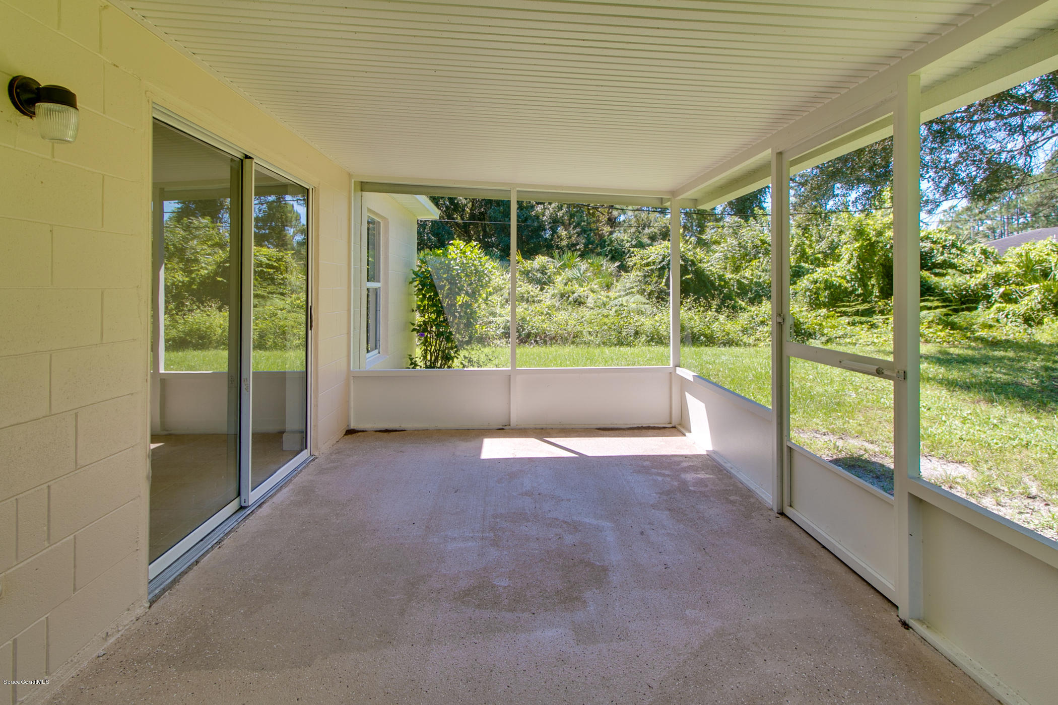 390 Warner Road Southwest Palm Bay, FL 32908 - Photo 29 of 32 Screened Porch Overlooking Backyard