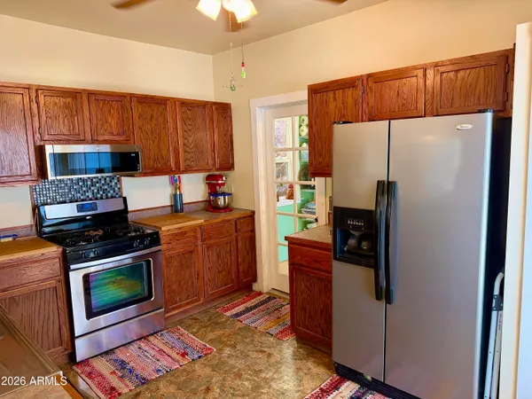 a kitchen with stainless steel appliances a stove sink and cabinets