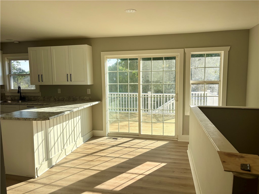 351 Randys Road Westminster, SC 29693 - Photo 9 of 30 A sun-filled kitchen with sleek cabinetry and a large sliding glass door opening to a bright outdoor deck.