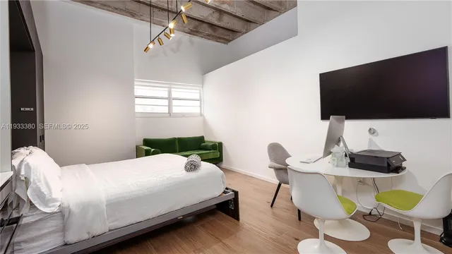 a view of kitchen island with stainless steel appliances granite countertop a sink a stove a dining table and chairs