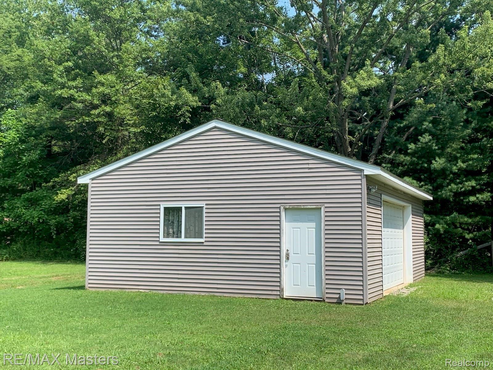 14550 Maxwell Road Carleton, MI 48117 - Photo 9 of 17 24'x32' Outbuilding featuring concrete floor, electricity & service door.