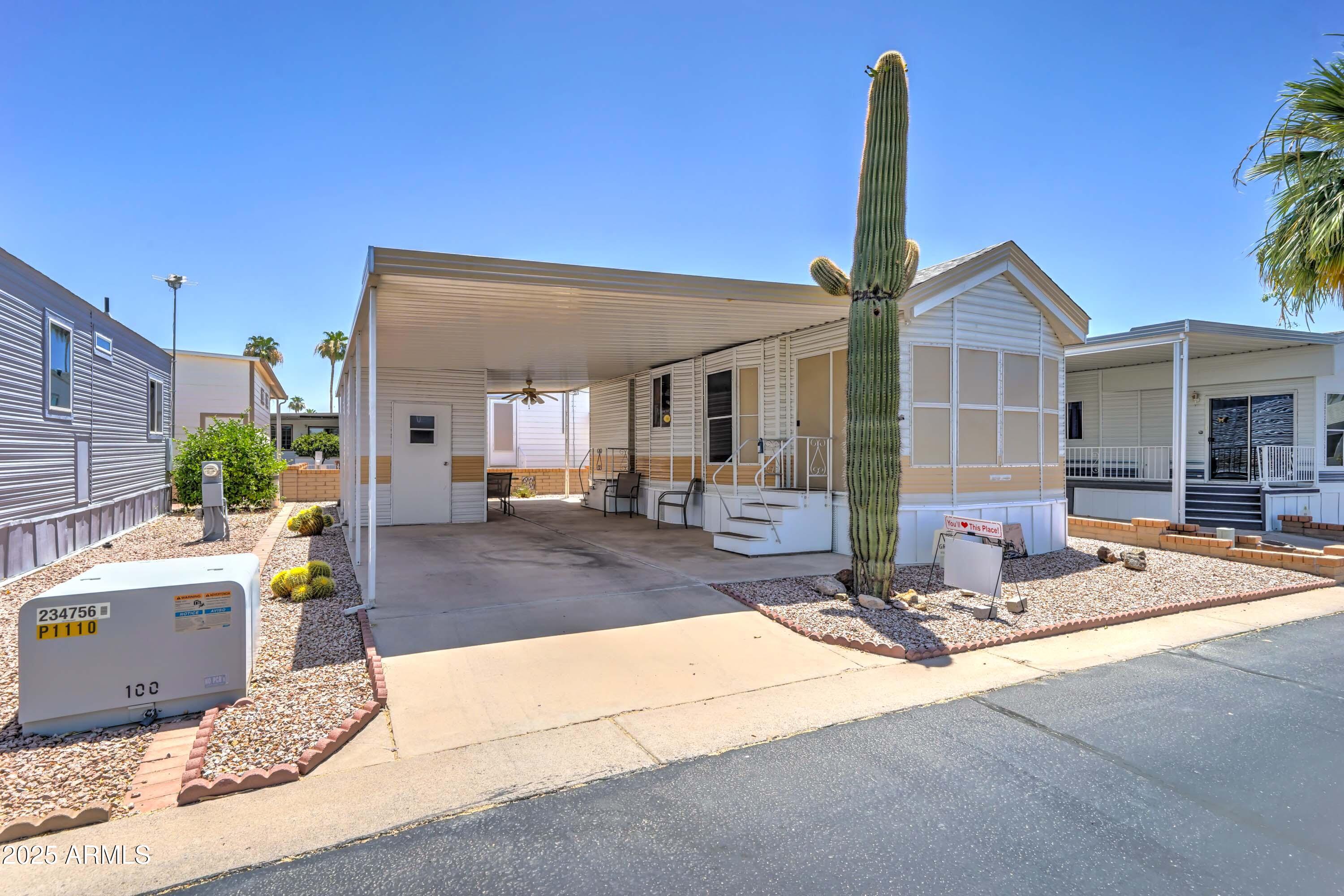 111 South Greenfield Road, Unit 405 Mesa, AZ 85206 - Photo 11 of 22 a front view of a house with a garden and patio
