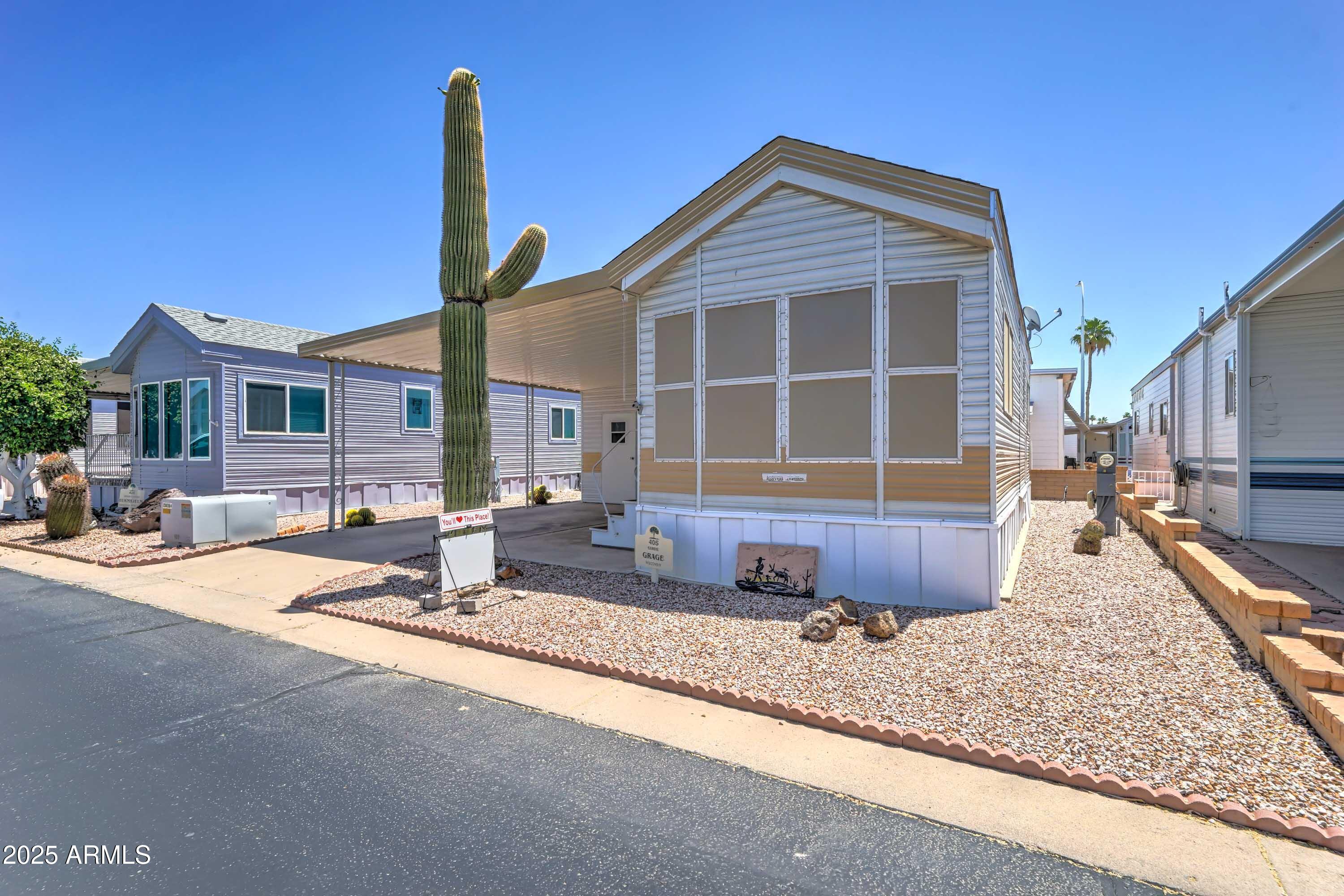 111 South Greenfield Road, Unit 405 Mesa, AZ 85206 - Photo 12 of 22 a front view of a house with swimming pool and sitting area